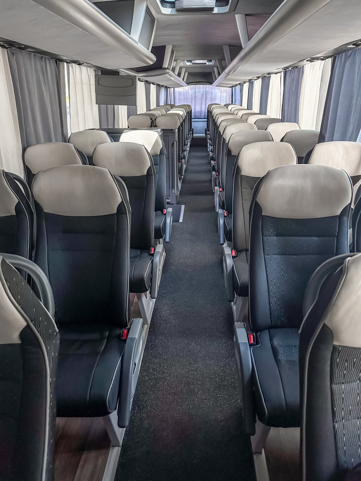 Row of coach bus seats viewed from the aisle